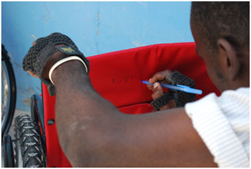 Rony writing his name on his chair